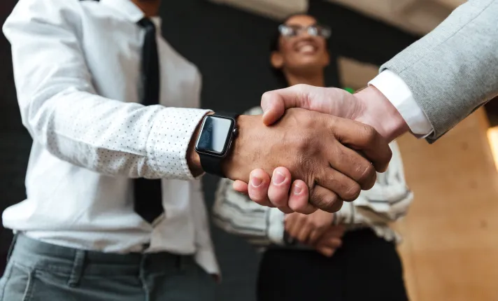 Personas cerrando un acuerdo con un apretón de manos